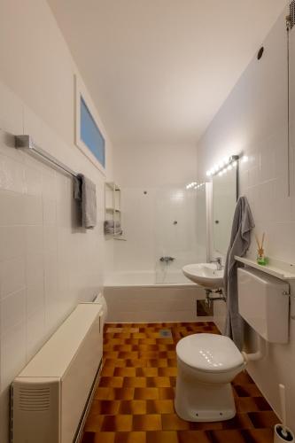 a white bathroom with a toilet and a sink at Wohhhlfühl Appartement im Zentrum Graz in Graz