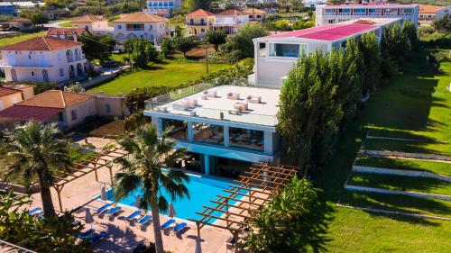 an aerial view of a house with a swimming pool at Belussi Beach Hotel & Suites in Kypseli