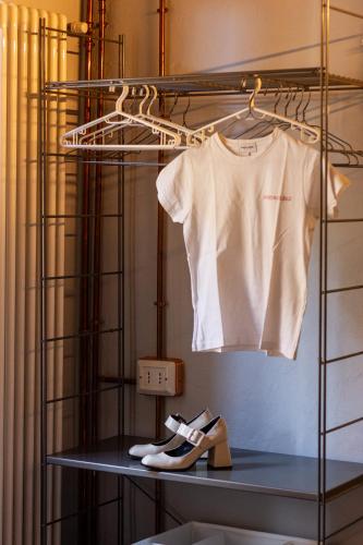 a white shirt and pair of shoes on a shelf at Maison di Lidia - Smart Holiday in Mantova