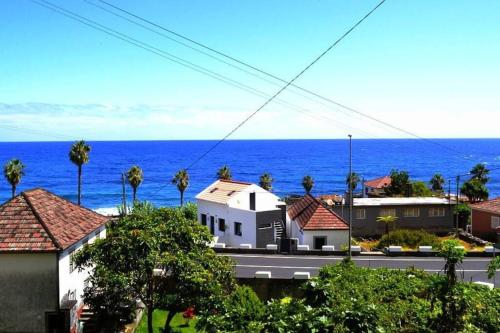 a city with the ocean in the background at Lazy Lizard Studio in Seixal