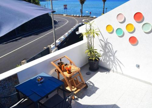 a balcony of a boat with a table and a road at Lazy Lizard Studio in Seixal