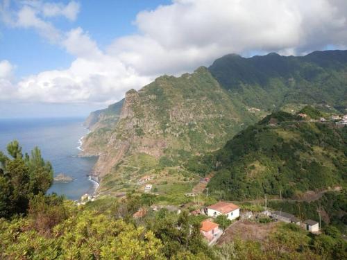 a view of a mountain with the ocean on it at Lazy Lizard Studio in Seixal