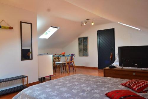 a bedroom with a bed and a dining room at Lazy Lizard Studio in Seixal