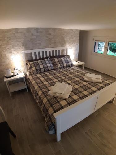 a bedroom with a large bed and two night stands at Roccia Bianca in Siracusa