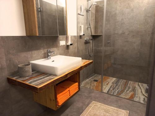 a bathroom with a sink and a shower at Gasthof Wachmann Ferienwohnung in Weiz