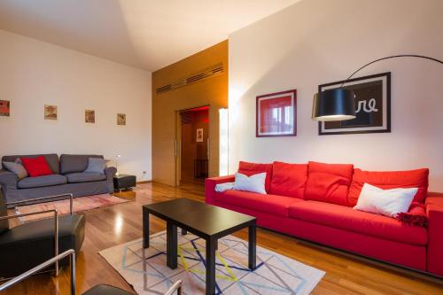 a living room with a red couch and a table at Arena Verona Centro in Verona
