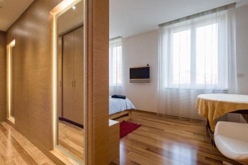 a hotel room with a door to a bedroom at Arena Verona Centro in Verona
