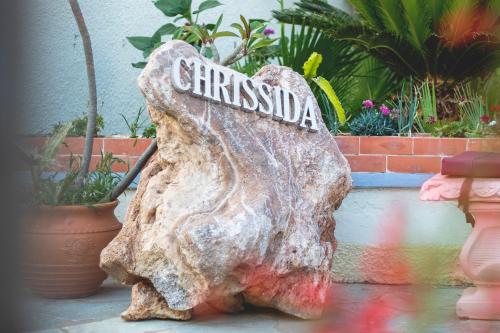 a rock with a sign on top of it at Chrissida Hotel in Nea Kydonia