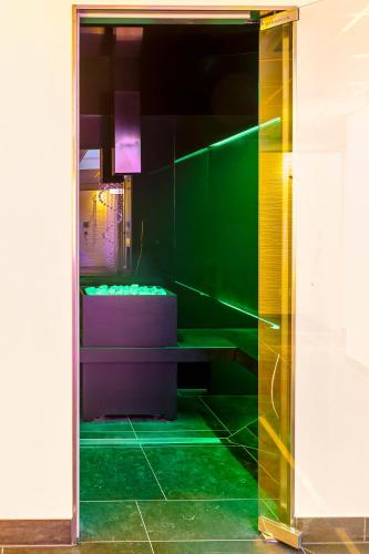 a bathroom with green floors and a green wall at Alpenlove - Adult SPA Hotel in Seefeld in Tirol