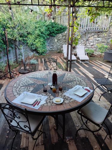 einen runden Tisch mit Stühlen und eine Flasche Wein in der Unterkunft Domaine Les Cascades in Ribaute