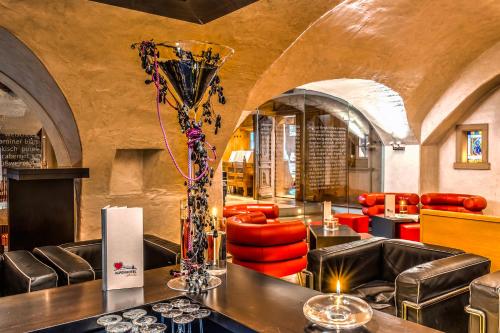a restaurant with a table with a vase on it at Alpenlove - Adult SPA Hotel in Seefeld in Tirol