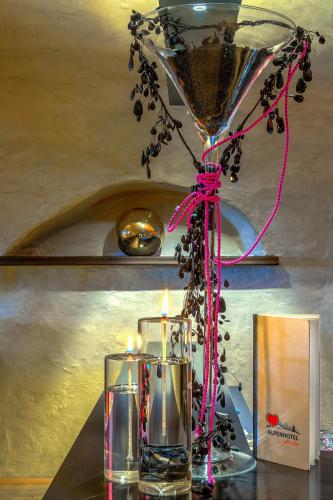a table with two candles and a chandelier at Alpenlove - Adult SPA Hotel in Seefeld in Tirol