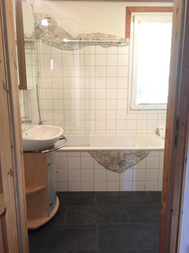 a bathroom with a sink and a bath tub at Alpenferienhaus Kreischberg in Sankt Lorenzen ob Murau