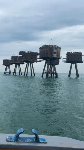 a group of wooden structures in the water at Central Townhouse Whitstable in Whitstable