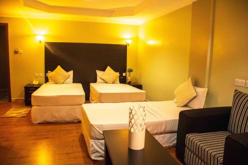 Un pat sau paturi într-o cameră la Panone Hotels - King'ori Kilimanjaro Airport
