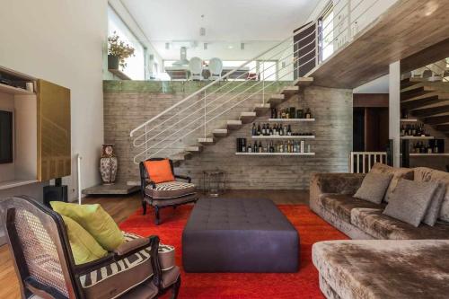 a living room with a couch and a stair case at Vila Spa Douro Piscina e acesso privado rio Douro in São Lourenço do Douro