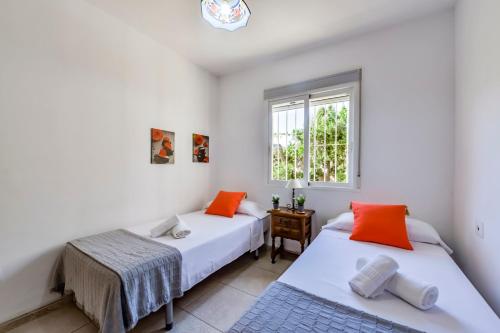 two beds in a room with a window at Villas Guzman - Alba in Calpe