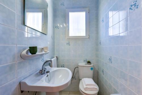 a white bathroom with a sink and a toilet at Villas Guzman - Alba in Calpe