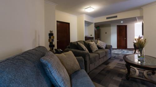a living room with two couches and a table at Hotel Costa Pacifico - Suite in Antofagasta