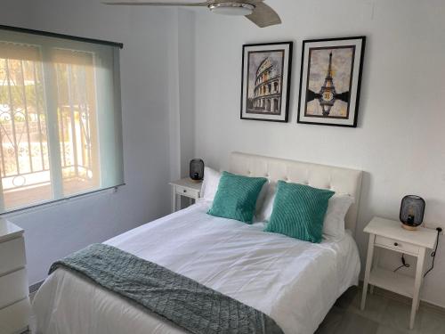 a white bedroom with a bed with green pillows at Apartment Near to Beach, Max Beach Club La Riviera-Mijas in Mijas
