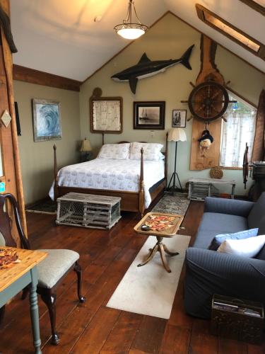 a bedroom with a bed and a couch and a table at SeaWatch Bed & Breakfast in Halifax