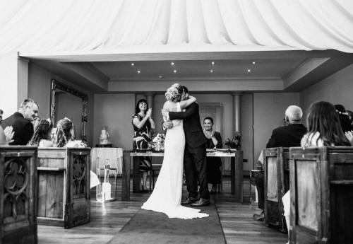 a bride and groom kissing at their wedding ceremony at The Rochford Hotel in Southend-on-Sea