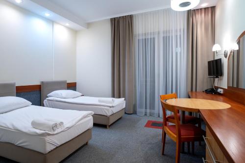 Ένα ή περισσότερα κρεβάτια σε δωμάτιο στο Hotel Lord Gorlice