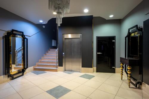 a hallway with a staircase and a door and a staircase at Hotel Lord Gorlice in Gorlice