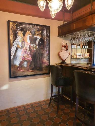 a bar with a painting on the wall at Ramme Fjordhotell - Unike Hoteller in Hvitsten