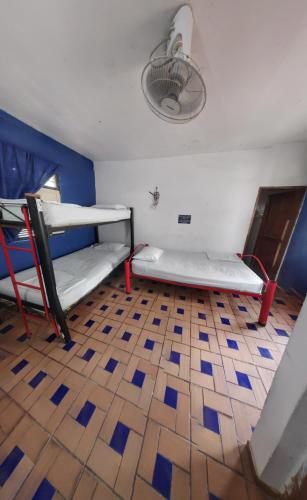 a room with two bunk beds and a tile floor at hostal alquimista in Taganga