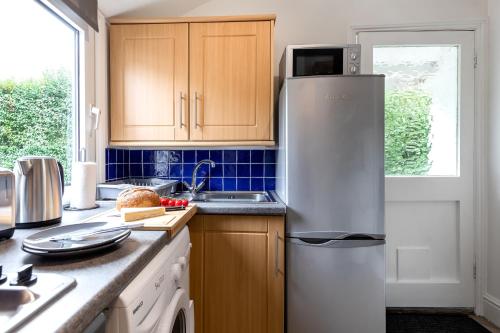 a kitchen with a refrigerator and a sink at Little Haven in Falmouth