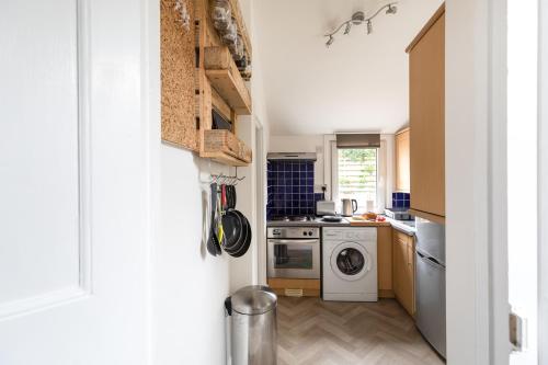 a kitchen with a washer and dryer in it at Little Haven in Falmouth