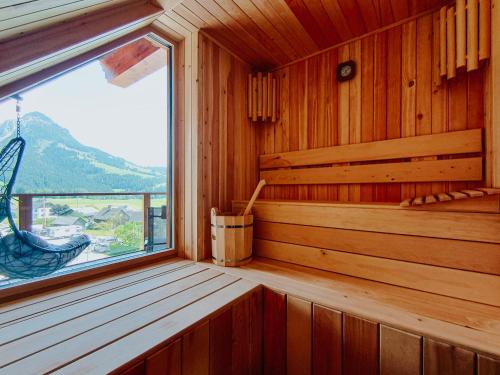 an empty sauna with a window and a swing at Downhill Lodge Tauplitz in Tauplitz