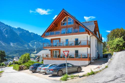 a house with cars parked in front of it at Downhill Lodge Tauplitz in Tauplitz