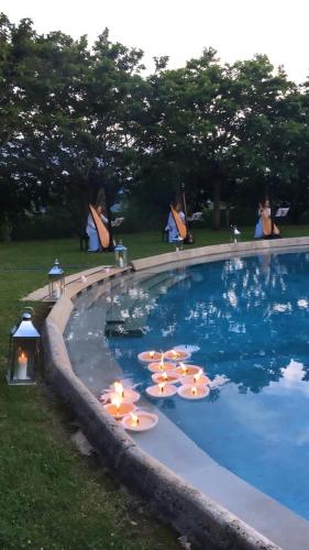 a swimming pool with lounge chairs and umbrellas in it at Château de Bagnols in Bagnols