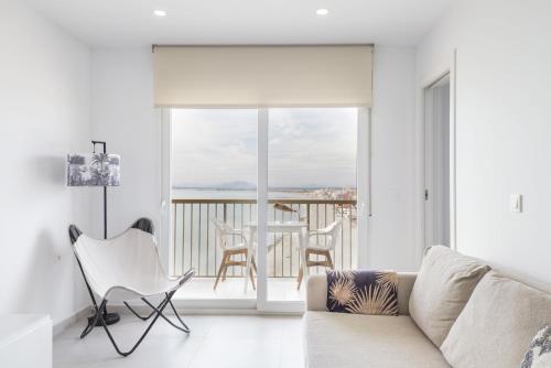a living room with a couch and a balcony at Sunset II in Santa Pola