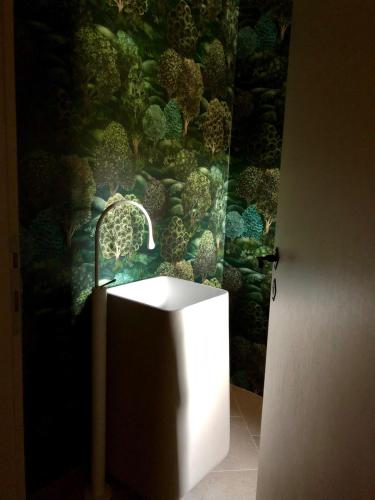 a bathroom with a white sink in front of a wall at Masseria D'Achille in Castel di Sangro