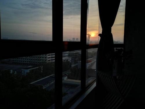 a view of the sunset from a window of a building at HINODE Geniehome 3BR free WIFI and CARPARK at Utropolis Shah Alam in Shah Alam