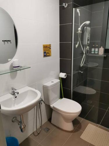 a bathroom with a shower and a toilet and a sink at HINODE Geniehome 3BR free WIFI and CARPARK at Utropolis Shah Alam in Shah Alam