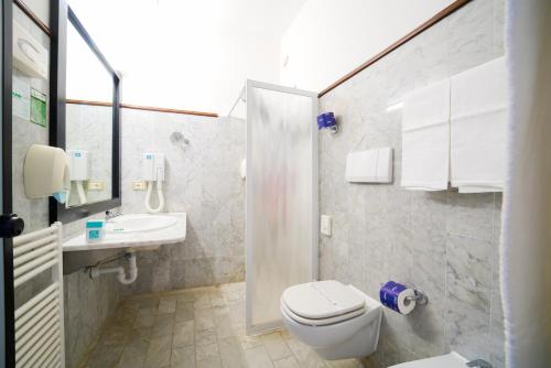 a bathroom with a toilet and a sink at Residence Le Acacie in Capoliveri