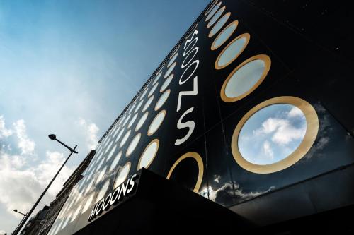 a black and gold sign on the side of a building at MOOONS Vienna in Vienna