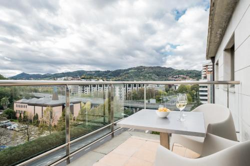 a balcony with a table and chairs and a view at Hotel Antik San Sebastián in Donostia-San Sebastián