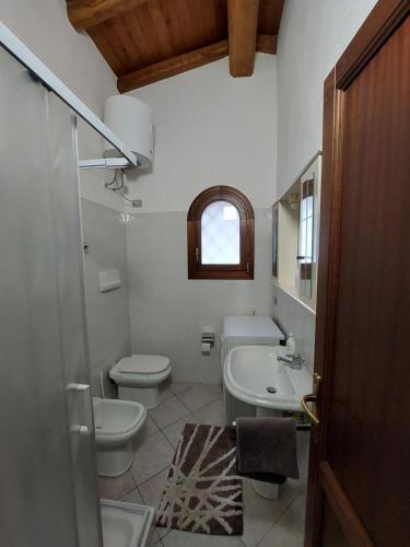 a bathroom with a toilet and a sink at Casa Stefano 2 in Lu Lioni