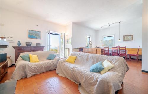 a living room with a couch and a dining room at Pet Friendly Home In Moneglia With Kitchen in Moneglia