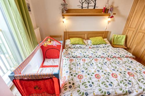a bedroom with a bed with a floral comforter at KUBO TATRY - Starý Smokovec in Smokovce