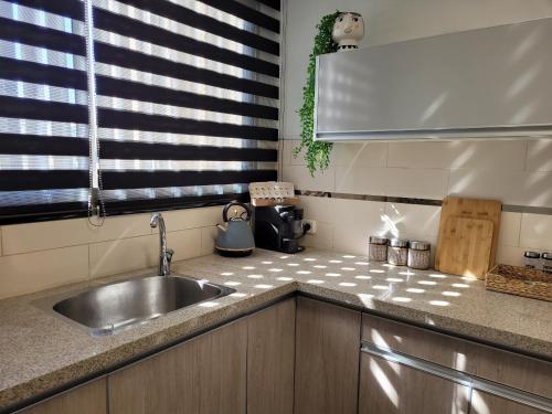 a kitchen counter with a sink and a window at view point relax in Eilat