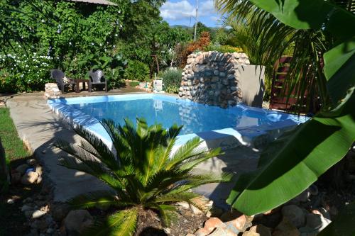a swimming pool with a bunch of rocks around it at ECOVILLA CORAL GARDEN in Baoruco