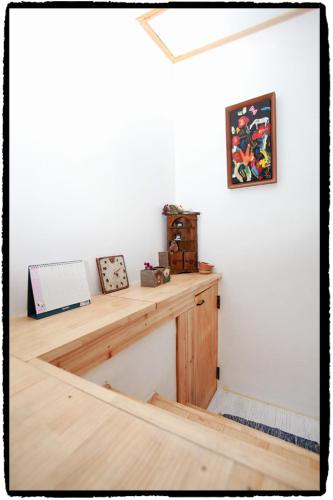 a room with a wooden desk with a picture on the wall at Dowon Guesthouse in Jeonju