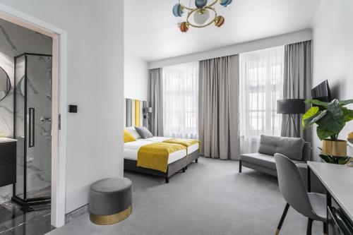une chambre d'hôtel avec un lit et un canapé dans l'établissement Old Town Residence - Premium Aparthotel, à Cracovie
