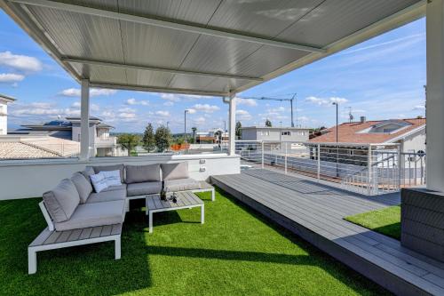 a patio with a couch and a table on a roof at Villette Dolci Luxury Homes in Peschiera del Garda